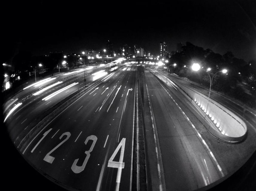 illuminated, night, transportation, road, road marking, mode of transport, speed, city, car, street light, street, motion, traffic, text, long exposure, land vehicle, light trail, communication, lighting equipment, high angle view