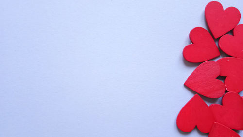 Close-up of heart shape on table against white background