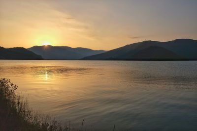 Scenic view of lake against sky during sunset