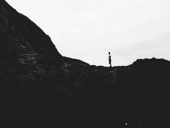 Silhouette of woman standing by tree