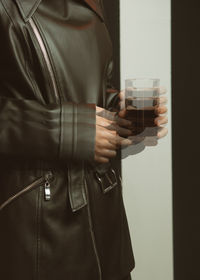 Midsection of man drinking glass