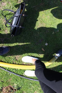 Low section of person standing on grassy field