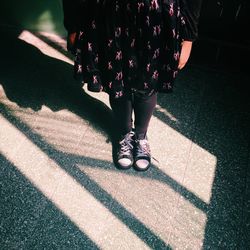 Low section of woman standing on floor