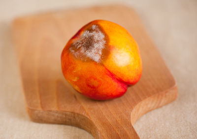 Close-up of rotting fruit on cutting board