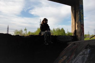 Side view of woman standing on rock