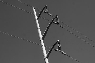 Low angle view of power line against clear sky