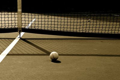 Tennis ball against net at court