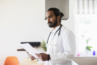 Young male doctor with white coat and stesthoscope