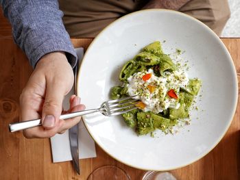 High angle view of person preparing food in plate