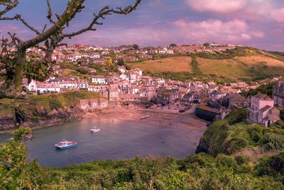 High angle view of townscape by sea against sky