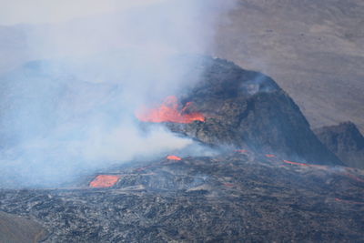 Smoke emitting from volcanic mountain