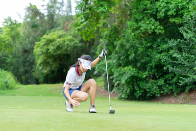 Full length of man with arms raised on golf course