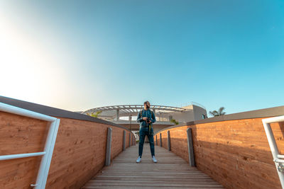 Man standing on staircase against sky