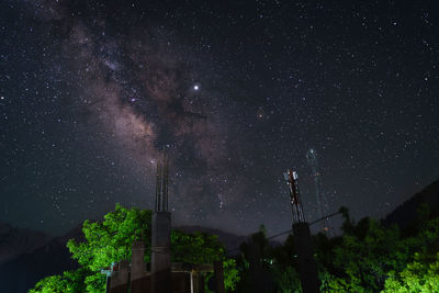 Low angle view of illuminated building against sky at night
