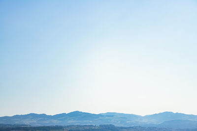 Scenic view of mountains against clear blue sky