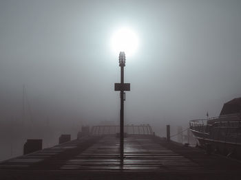 Street light on pier against sky