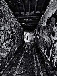 Empty alley amidst buildings in tunnel