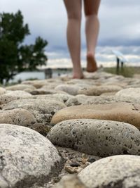 Bare foot walking on a cobblestone path with horizon in the distance