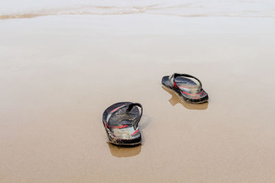 High angle view of abandoned shoes on beach