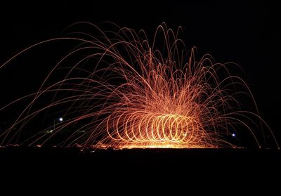 Low angle view of firework display at night