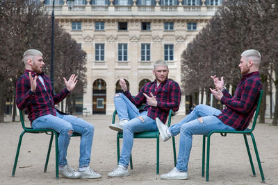 Multiple image of young man sitting on chairs against building