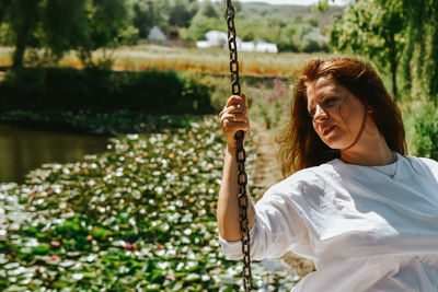 Young woman swinging at playground