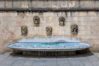 Luxembourg  city, in this photo gargoyles in the wall that spit their water into a small water bath