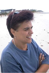 Smiling mid adult man sitting on beach