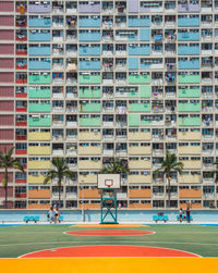 Playing field against buildings in city