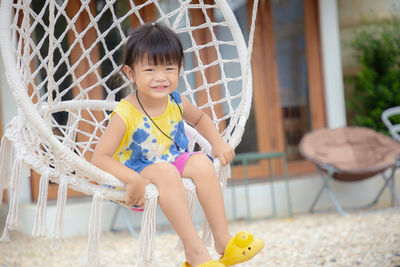 Portrait of smiling girl sitting outdoors