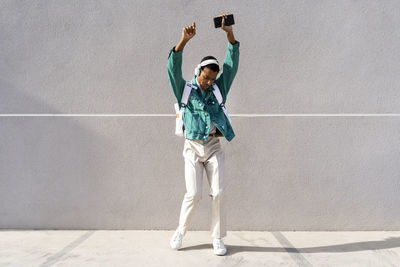 Full length of woman standing on wall