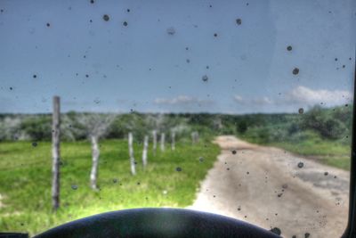 Close-up of wet road against sky