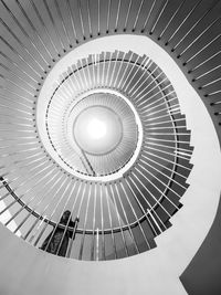 Low angle view of woman walking on spiral staircase