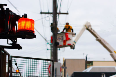 Low angle view of road signal against sky