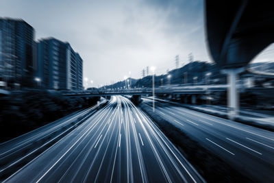 Blurred motion of highway against sky in city