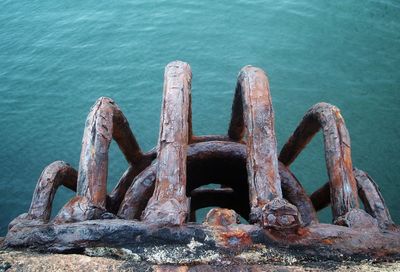 Close-up of rusty chain on boat by sea