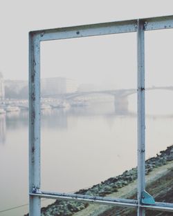 Close-up of bridge over sea against clear sky