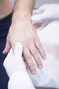 Cropped hands of doctor holding patient 