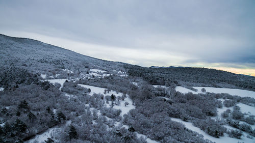 Scenic view of snow covered mountains against sky