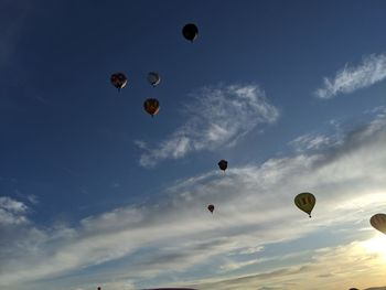 Low angle view of hot air balloons flying in sky