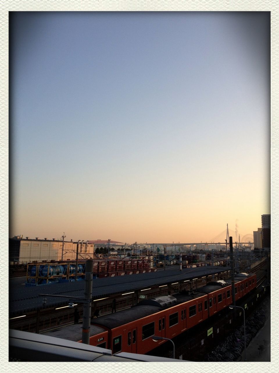 copy space, clear sky, transfer print, transportation, built structure, architecture, auto post production filter, sunset, city, building exterior, high angle view, road, car, connection, bridge - man made structure, outdoors, mode of transport, dusk, sky, illuminated