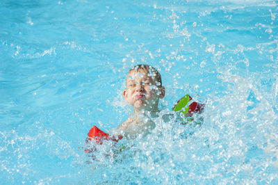 Boy swimming in pool