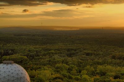 Sunset from a radar station discover your city. scenic view of landscape against sky during sunset.