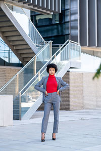 A young african-american businesswoman wearing a red turtleneck and a suit in a business building