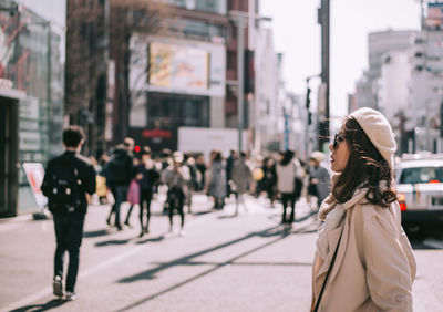 Rear view of woman walking on city street