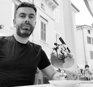 Portrait of young man holding ice cream