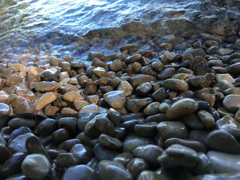 Close-up of pebbles in sea