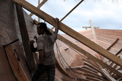 Low angle view of man working at construction site