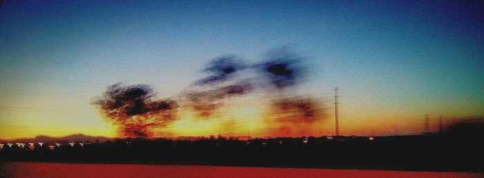 Scenic view of landscape against sky at sunset