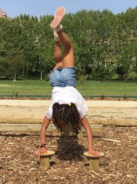 Rear view of girl playing on field